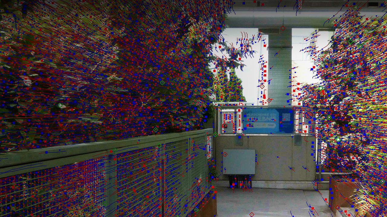 an abstract artistic installation in a corridor with colorful flowing patterns and displays the scene features a railing on the left a blue backdrop with information panels and greenery framing the walkway digital production An abstract artistic installation in a corridor with colorful flowing patterns and displays. The scene features a railing on the left, a blue backdrop with information panels, and greenery framing the walkway.