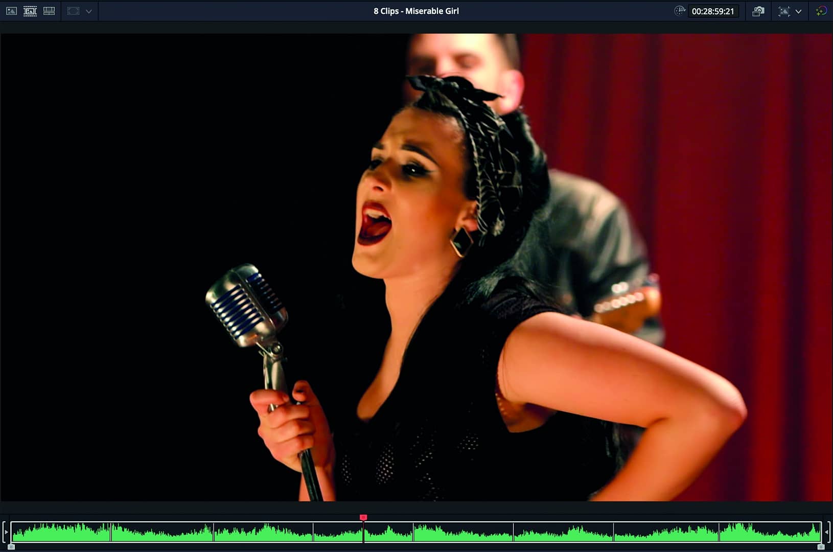 a woman singing passionately into a vintage microphone on stage digital production A woman singing passionately into a vintage microphone on stage.