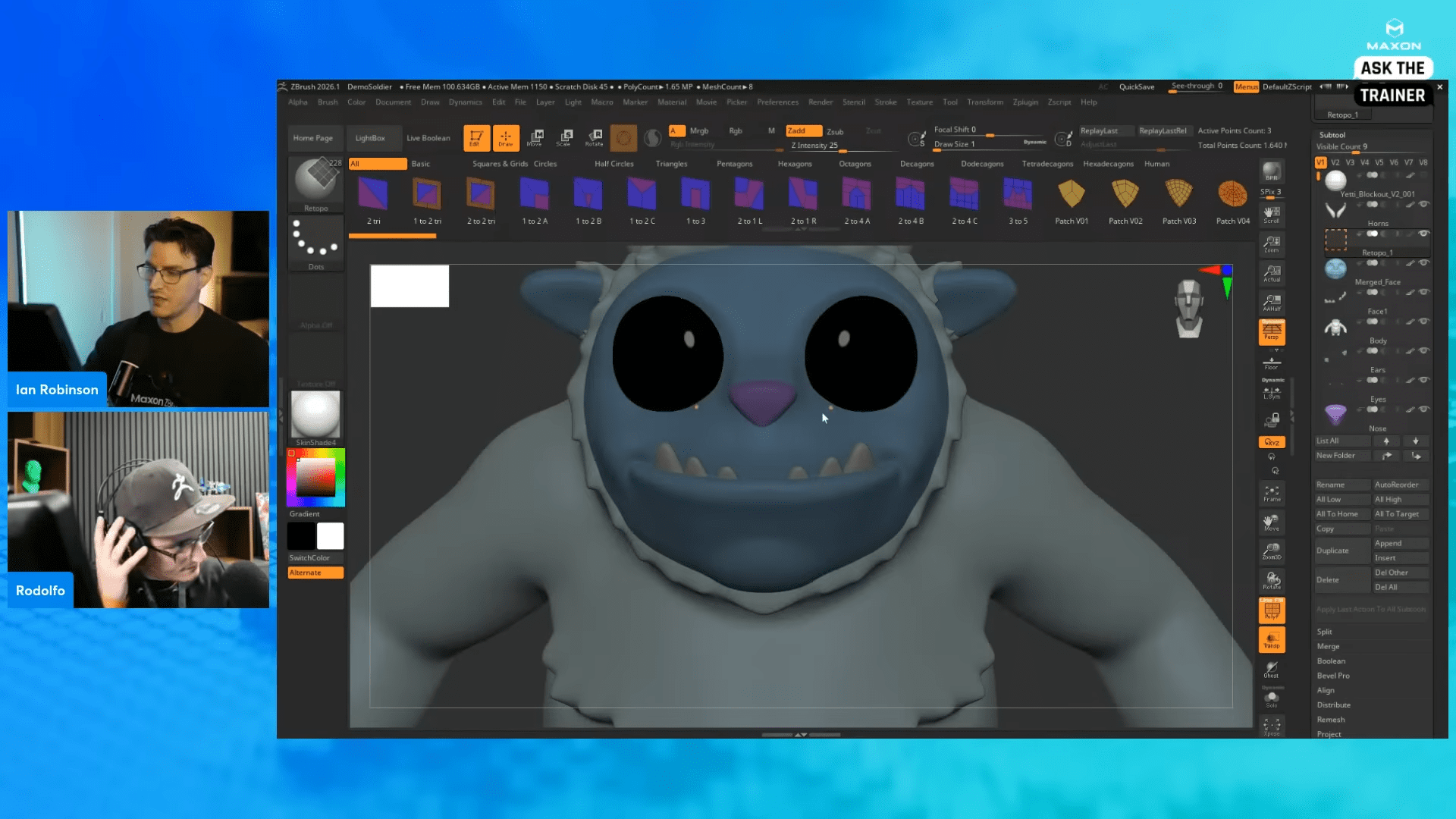 two digital artists working on a character model in zbrush one artist is focused on the screen while the other is wearing headphones and appears to be deep in thought the character on the screen is a blue monster with large black eyes and a toothy grin wearing a hoodie digital production Two digital artists working on a character model in ZBrush. One artist is focused on the screen, while the other is wearing headphones and appears to be deep in thought. The character on the screen is a blue monster with large black eyes and a toothy grin, wearing a hoodie.